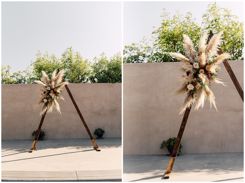 triangle wood ceremony arch with pampas grass floral arrangement