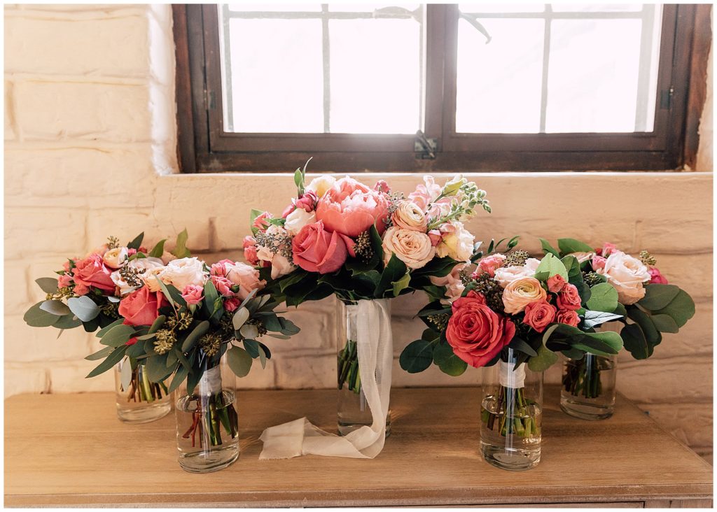 pink, blush, and coral wedding bouquets with coral charm peonies and eucalyptus